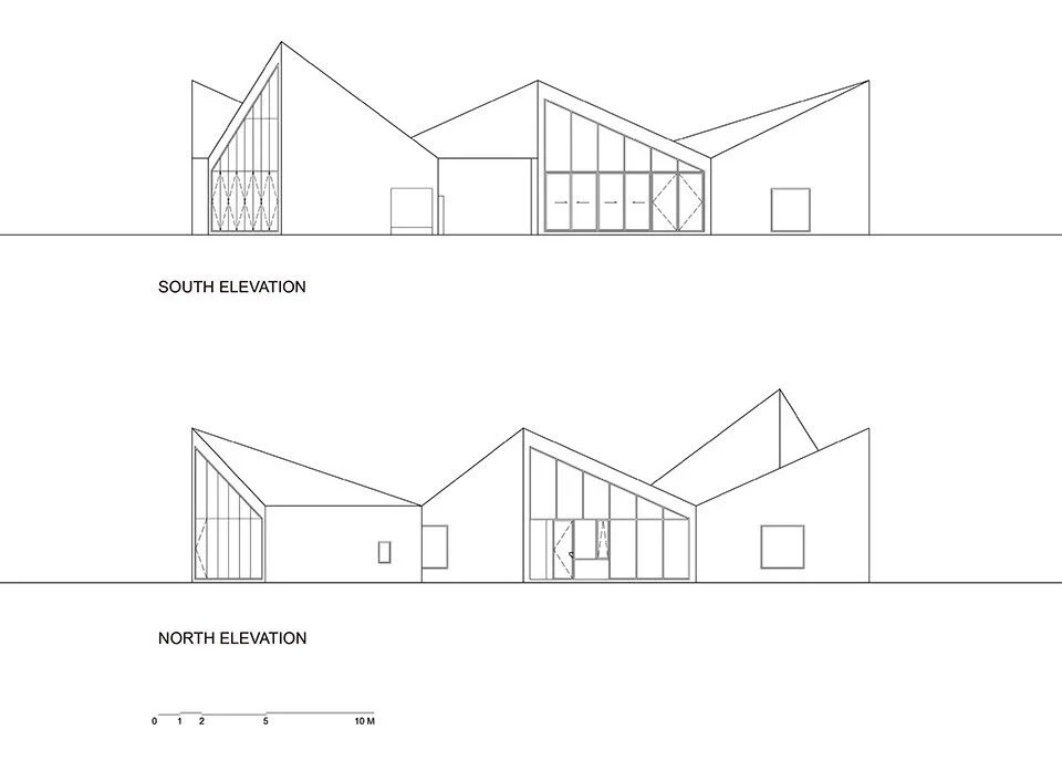 کتابخانه روستایی آتلیه Xi مجموعه ای از بلوک های زاویه دار در یک زمین پوشیده از گل است
