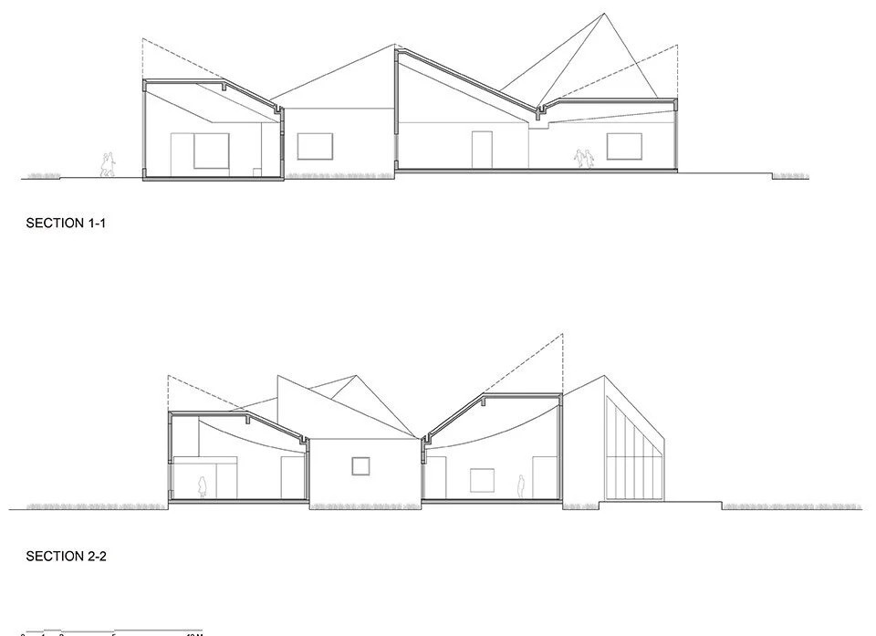 کتابخانه روستایی آتلیه Xi مجموعه ای از بلوک های زاویه دار در یک زمین پوشیده از گل است