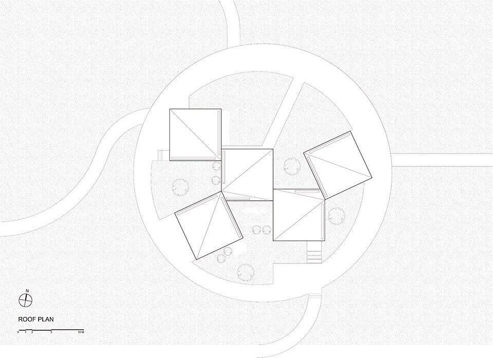 کتابخانه روستایی آتلیه Xi مجموعه ای از بلوک های زاویه دار در یک زمین پوشیده از گل است